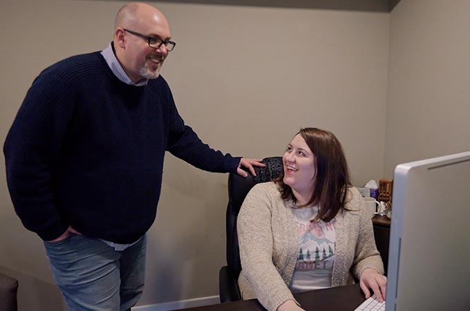 David Hosay and Kayla Bitner Discussing a Social Media Ad Strategy in front of a computer at Sublime Media Group's office in Bowling Green, KY
