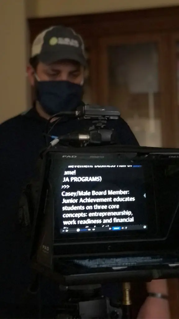 Junior Achievement Business Hall of Fame virtual event script is show on the screen of a field teleprompter