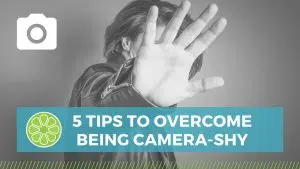 person with hand blocking camera