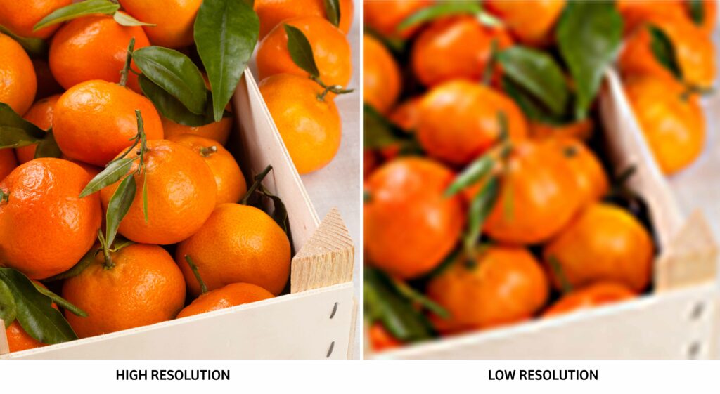 A side-by-side comparison of two images of tangerine fruit in wooden crates. The high-quality image is clear, while the low-quality image is blurry.