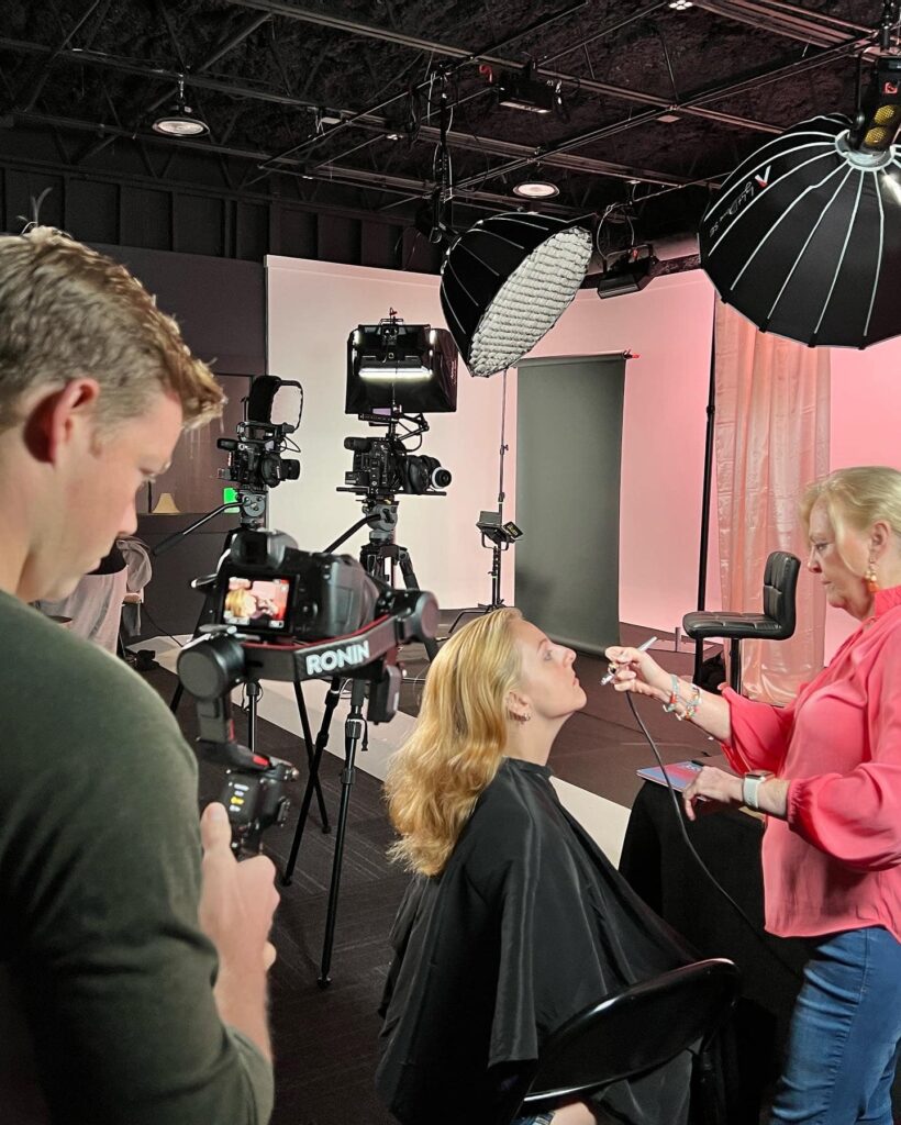 actress getting makeup put on in a studio