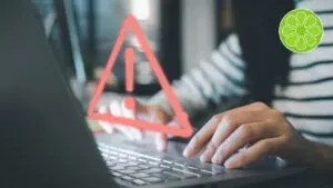 alert button over a laptop showing a website error