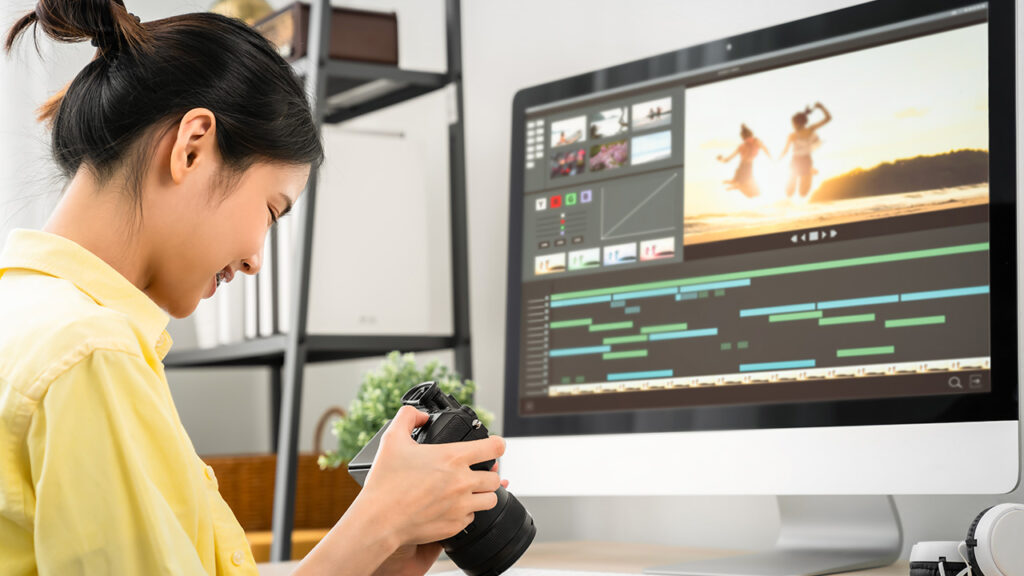 content marketer looking at camera footage in front of an imac computer