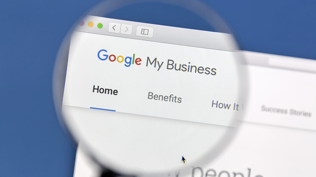 a magnifying glass is showing Google My Business text and Google Logo on a website browser